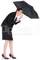 Businesswoman holding a black umbrella