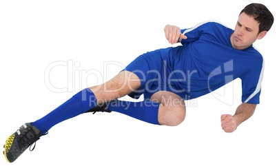 Football player in blue kicking