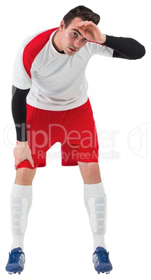 Football player in white catching his breath