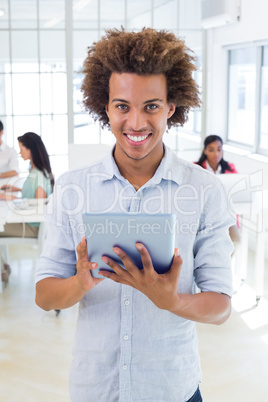 Casual businessman using tablet pc