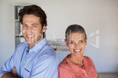 Casual smiling business team standing back-to-back