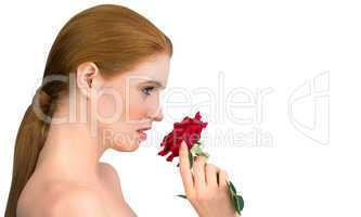 Natural beauty posing and smelling red rose