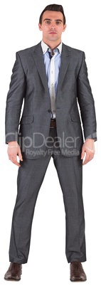 Businessman in grey suit frowning at camera