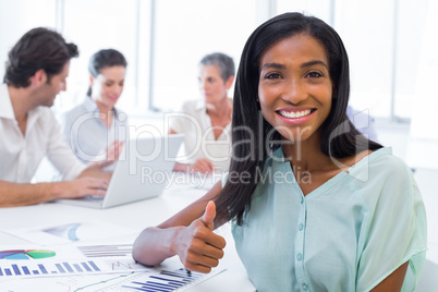 Attractive businesswoman giving the thumb of approval