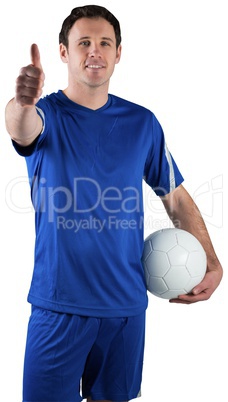 Handsome football player holding the ball Handsome football player holding the ball