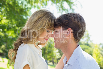 Cute couple facing each other in the park