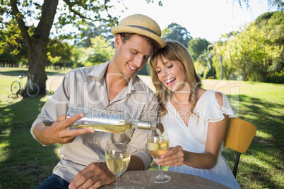 Cute couple drinking white wine together outside