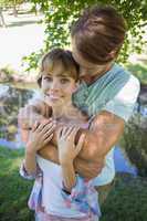 Affectionate young couple standing together in the park girl smi