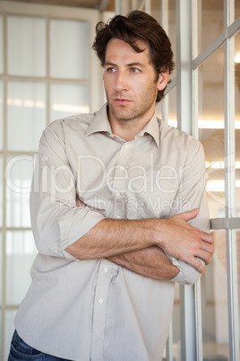 Casual worried businessman leaning on window