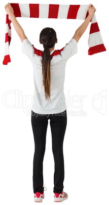 Football fan waving red and white scarf