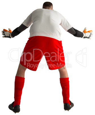 Goalkeeper in red and white ready to catch