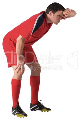 Tired football player bending over