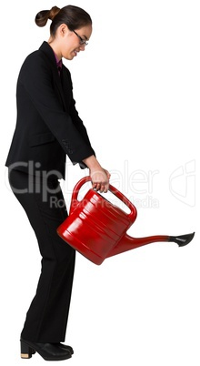 Businesswoman using red watering can