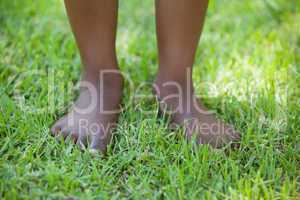 Little boys legs standing on grass