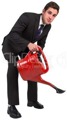 Businessman watering with red can