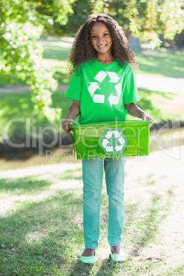 Young environmental activist smiling at the camera holding box