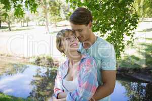 Affectionate young couple standing together in the park