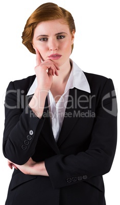 Thinking redhead businesswoman in suit