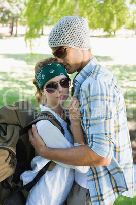 Active couple embracing each other on a hike