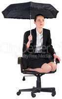 Businesswoman holding a black umbrella