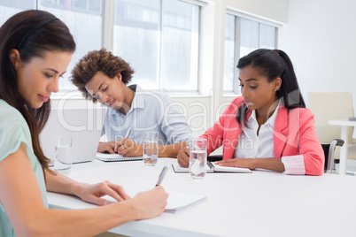 Attractive business people working hard on plans Attractive business people working hard on plans