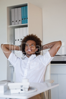 Relaxed casual businessman leaning back at his desk