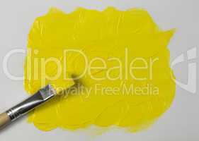 Yellow paint with paintbrush