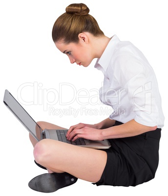 Businesswoman sitting on floor using laptop