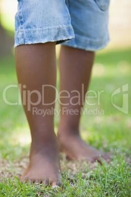Little boys legs standing on grass