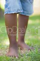 Little boys legs standing on grass