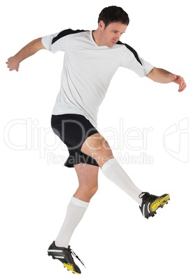 Football player in white kicking