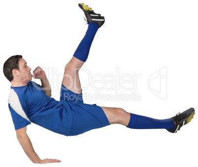 Football player in blue kicking