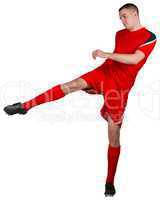 Fit football player playing and kicking