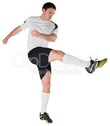 Football player in white kicking