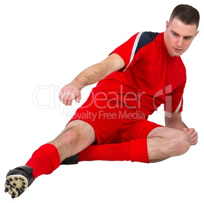 Fit football player playing and kicking