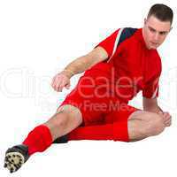 Fit football player playing and kicking