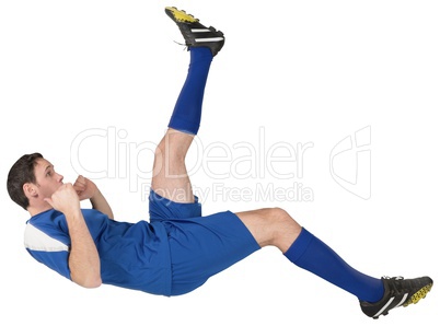 Football player in blue kicking