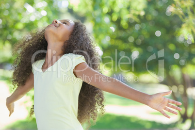 Young girl smiling with arms outstretched