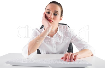 Bored businesswoman typing on keyboard