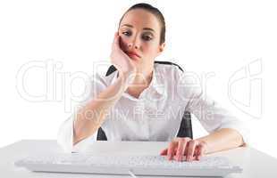 Bored businesswoman typing on keyboard