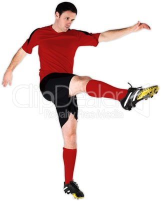 Football player in red kicking