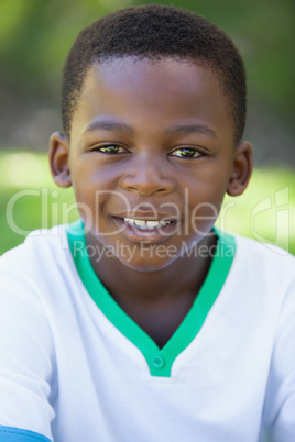 Cute boy smiling at the camera in the park