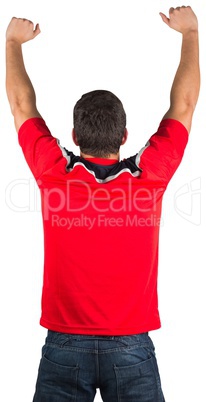 Excited football fan in red cheering