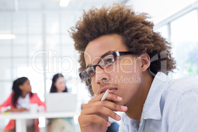 Attractive businessman wearing glasses and thinking