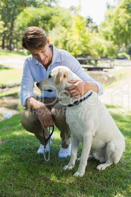 Handsome man with his labrador in the park