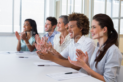 Casual business team clapping at presentation
