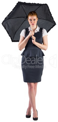 Pretty redhead businesswoman holding umbrella