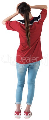 Football fan in red jersey with hands on head