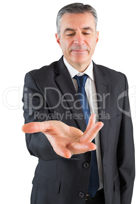 Mature businessman standing with hand out