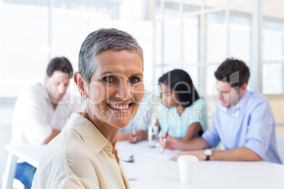 Attractive businesswoman smiling in the workplace